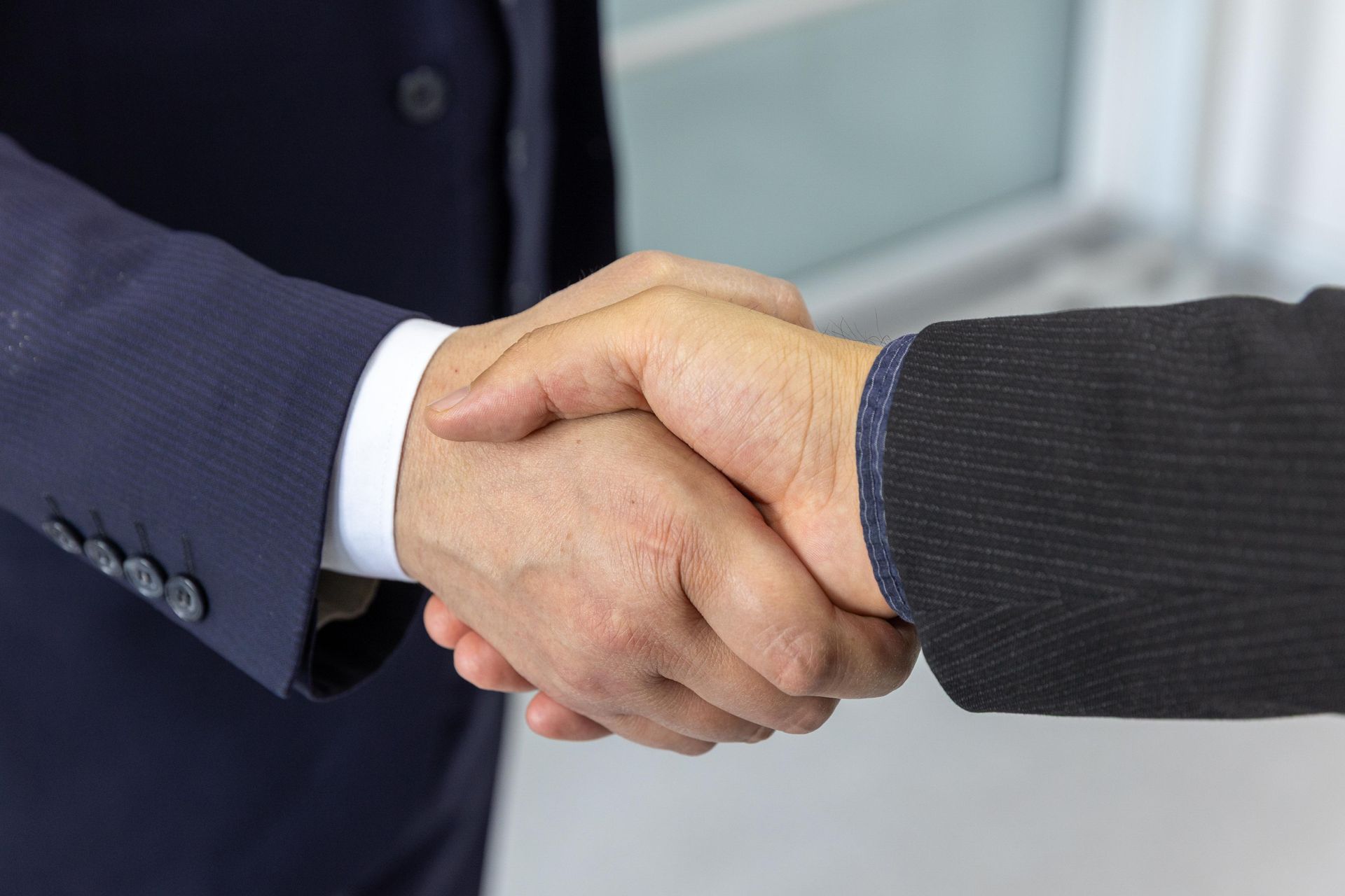 Business partners shaking hands — RK Talent Sphere